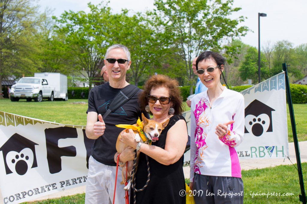 Georgie crosses the finish line at the Monmouth County SPCA Dog Walk with his mom and two friends.